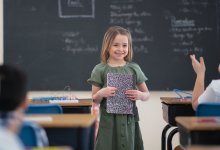 Photo of elementary school student in front of classroom
